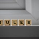 similar cubes with rules inscription on windowsill in building